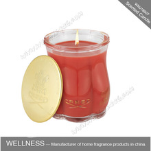 red or pink soy wax scented candle in glass jar